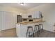 Eat-in kitchen with butcher block countertops, bar stools, and stainless steel appliances at 1065 Universal Rest Pl, Kissimmee, FL 34744