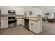 Modern kitchen with stainless steel appliances, white cabinets, wood countertops, and wood style flooring at 1065 Universal Rest Pl, Kissimmee, FL 34744