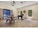 Bright living area with a table, chairs, and natural light from large windows at 1065 Universal Rest Pl, Kissimmee, FL 34744