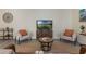 Well-decorated living room with modern furnishings, wood-look flooring, and plenty of natural light at 1065 Universal Rest Pl, Kissimmee, FL 34744