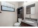 Elegant half bath with granite vanity, modern lighting, and sleek black cabinet at 10800 Fernando St, Orlando, FL 32825