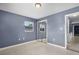 This cozy bedroom offers a built-in closet with sliding doors, a window, and a neutral paint color at 10800 Fernando St, Orlando, FL 32825