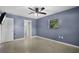 Bright bedroom featuring a ceiling fan and a door to the bathroom at 10800 Fernando St, Orlando, FL 32825