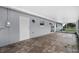 Exterior view of covered patio with tile flooring, sliding glass doors and access doors at 10800 Fernando St, Orlando, FL 32825