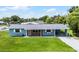 Charming single story home featuring a well maintained lawn, inviting entrance, and covered parking at 10800 Fernando St, Orlando, FL 32825