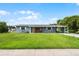 Charming single story home featuring a well maintained lawn, inviting entrance, and covered parking at 10800 Fernando St, Orlando, FL 32825