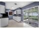This kitchen features white cabinets, modern appliances, and sliding door access to the patio at 10800 Fernando St, Orlando, FL 32825