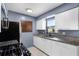 This kitchen area has granite counters, stainless steel appliances and ample cabinet space at 10800 Fernando St, Orlando, FL 32825