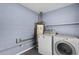 This laundry room has modern appliances and concrete block walls at 10800 Fernando St, Orlando, FL 32825