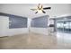 Open-concept living space featuring a door to the kitchen and a sliding door to the backyard at 10800 Fernando St, Orlando, FL 32825