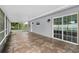 View of the patio with tile flooring and access to the backyard through sliding glass doors at 10800 Fernando St, Orlando, FL 32825