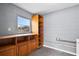 The utility room has shelving, a window, and a concrete block wall at 10800 Fernando St, Orlando, FL 32825