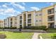 Well-maintained condo building with lush landscaping and multiple balconies under a partly cloudy sky at 1125 Lake Shadow Cir # 5308, Maitland, FL 32751