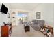 Bright living room with a ceiling fan, sliding glass doors to a balcony, and comfortable seating at 1125 Lake Shadow Cir # 5308, Maitland, FL 32751