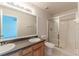 Bright bathroom with a double sink vanity, large mirror, and a glass-enclosed shower at 1129 Royal Ridge Dr, Davenport, FL 33896