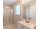 Clean bathroom with a glass-enclosed shower and a single sink vanity at 1129 Royal Ridge Dr, Davenport, FL 33896