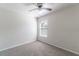 Neutral bedroom featuring a ceiling fan and natural light from a window at 1129 Royal Ridge Dr, Davenport, FL 33896