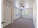 Cozy bedroom with carpet, windows, and a ceiling fan, offering comfort at 1129 Royal Ridge Dr, Davenport, FL 33896