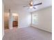 Bedroom with carpet, a ceiling fan, and a glimpse into the bathroom and closet at 1129 Royal Ridge Dr, Davenport, FL 33896