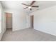 Bedroom with ceiling fan and doorways to bathroom and closet at 1129 Royal Ridge Dr, Davenport, FL 33896