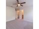 Spacious bedroom with a ceiling fan and a view of the bathroom and closet at 1129 Royal Ridge Dr, Davenport, FL 33896