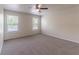 Bedroom featuring carpet, windows, and a ceiling fan, with ample natural light at 1129 Royal Ridge Dr, Davenport, FL 33896