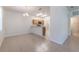 Bright dining area open to kitchen, featuring tile floors and a modern chandelier at 1129 Royal Ridge Dr, Davenport, FL 33896