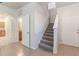 Hallway features stairs, tile flooring, and doorways leading to rooms at 1129 Royal Ridge Dr, Davenport, FL 33896