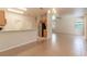 Open-concept living space with neutral tile flooring connecting the kitchen to the living room at 1129 Royal Ridge Dr, Davenport, FL 33896