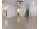 Spacious living room with tile floors, staircase, and neutral walls, adjacent to the kitchen area at 1129 Royal Ridge Dr, Davenport, FL 33896