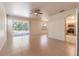 Bright, open living room with tile flooring, ceiling fan, and sliding glass doors leading to the pool at 1129 Royal Ridge Dr, Davenport, FL 33896