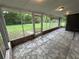 Enclosed back porch featuring screened windows, tile flooring, and a view of the backyard at 1130 W Lake Brantley Rd, Altamonte Springs, FL 32714