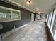 Spacious back porch featuring tile flooring and a screened enclosure at 1130 W Lake Brantley Rd, Altamonte Springs, FL 32714