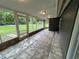 Spacious back porch with brick accents, screened windows, and tile flooring at 1130 W Lake Brantley Rd, Altamonte Springs, FL 32714