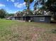 Expansive backyard featuring a screen porch, lush lawn, and mature trees at 1130 W Lake Brantley Rd, Altamonte Springs, FL 32714