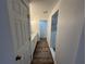 Hallway view of remodeled bathroom with white vanity, new sink, and updated walk-in shower at 1130 W Lake Brantley Rd, Altamonte Springs, FL 32714