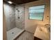 Updated bathroom featuring stylish marble wall tile and a shower with a modern rainfall showerhead at 1130 W Lake Brantley Rd, Altamonte Springs, FL 32714