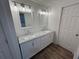 Elegant bathroom featuring double sinks with marble countertops, and modern lighting at 1130 W Lake Brantley Rd, Altamonte Springs, FL 32714