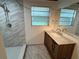 Renovated bathroom featuring a new vanity, marble wall tile, and rainfall showerhead at 1130 W Lake Brantley Rd, Altamonte Springs, FL 32714