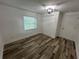 Well-lit bedroom featuring wood-look floors and a closet with sliding doors at 1130 W Lake Brantley Rd, Altamonte Springs, FL 32714