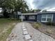 Inviting single-story home with a quaint walkway and lush landscaping enhancing curb appeal at 1130 W Lake Brantley Rd, Altamonte Springs, FL 32714