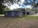 An exterior view of the home showing the large windows and professional landscaping at 1130 W Lake Brantley Rd, Altamonte Springs, FL 32714