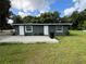Exterior showcasing a grey home with a small patio and lawn at 1130 W Lake Brantley Rd, Altamonte Springs, FL 32714