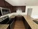 Charming kitchen features granite countertops, sleek black appliances, and dark cabinets at 1130 W Lake Brantley Rd, Altamonte Springs, FL 32714