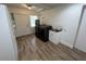 Bright laundry room featuring wood-look flooring, black washer/dryer, and a utility sink at 1130 W Lake Brantley Rd, Altamonte Springs, FL 32714