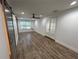 Open layout featuring new flooring, fresh paint, a ceiling fan, sliding barn doors, and glass doors at 1130 W Lake Brantley Rd, Altamonte Springs, FL 32714