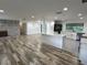 Open living area with hardwood flooring, a brick fireplace, and modern kitchen island at 1130 W Lake Brantley Rd, Altamonte Springs, FL 32714