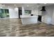 Spacious open-concept living area featuring hardwood floors and seamlessly connecting to the modern kitchen at 1130 W Lake Brantley Rd, Altamonte Springs, FL 32714