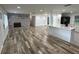 Bright, open layout with wood flooring, exposed brick fireplace, and a kitchen island at 1130 W Lake Brantley Rd, Altamonte Springs, FL 32714