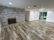 Bright living area with hardwood floors, a brick fireplace, and sliding door access to the screened in porch at 1130 W Lake Brantley Rd, Altamonte Springs, FL 32714
